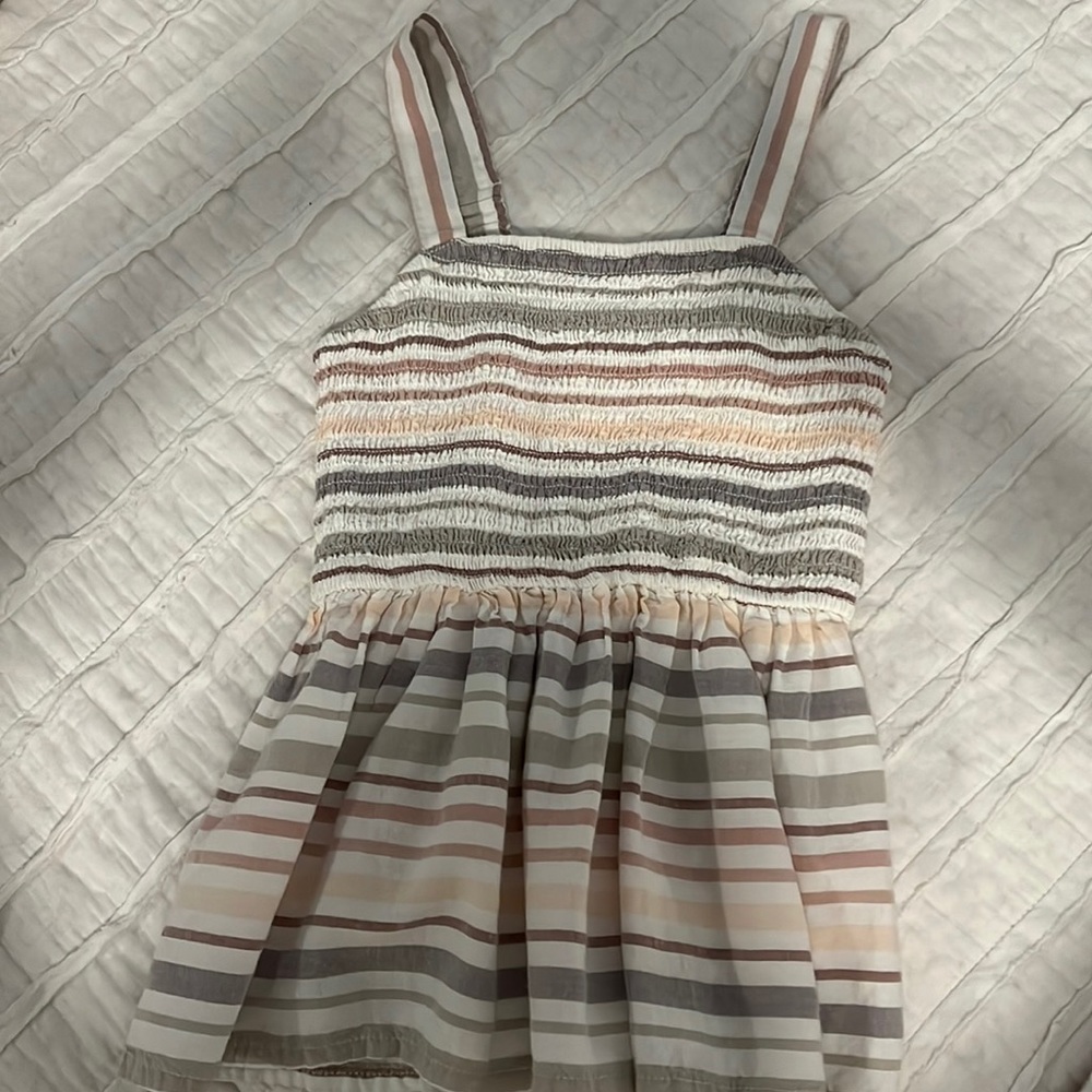 Stripped top. Ribbed material ish and flowy on bottom